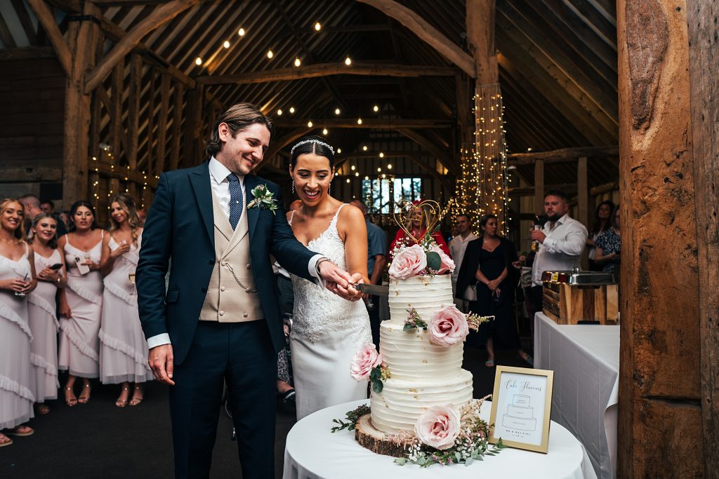 bride and groom cut cake