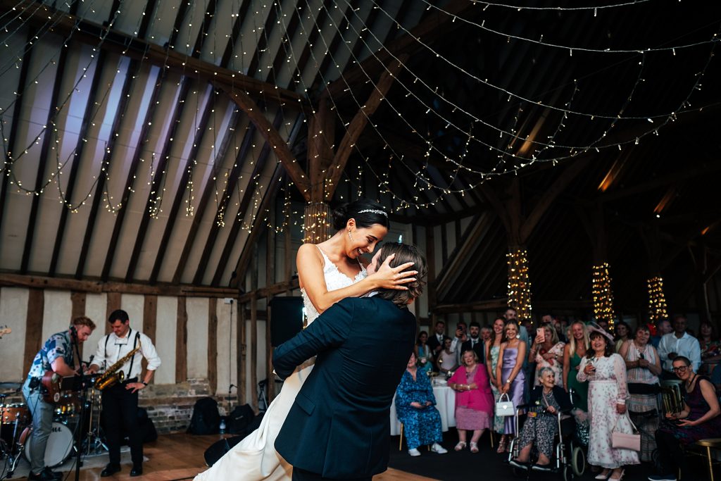 groom lifts bride on dance floor