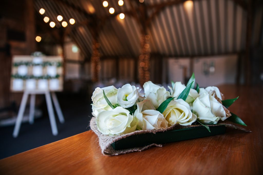 white rose button holes on bar at Blake Hall