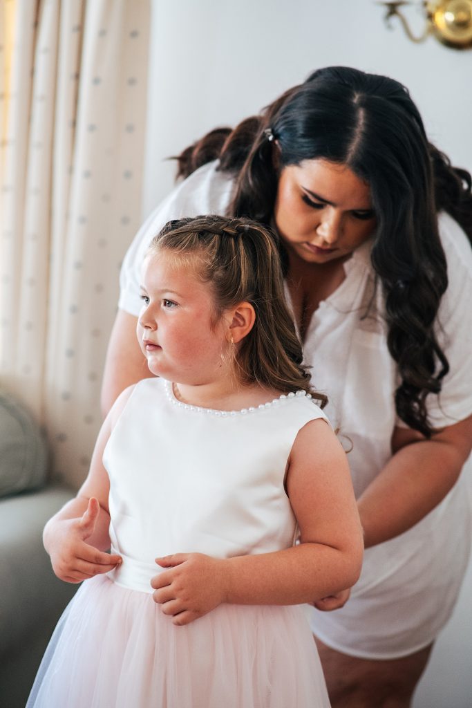 flower girl has dress done up