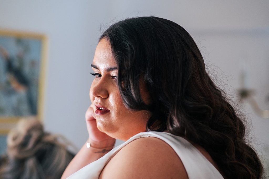 bride adjusts earring