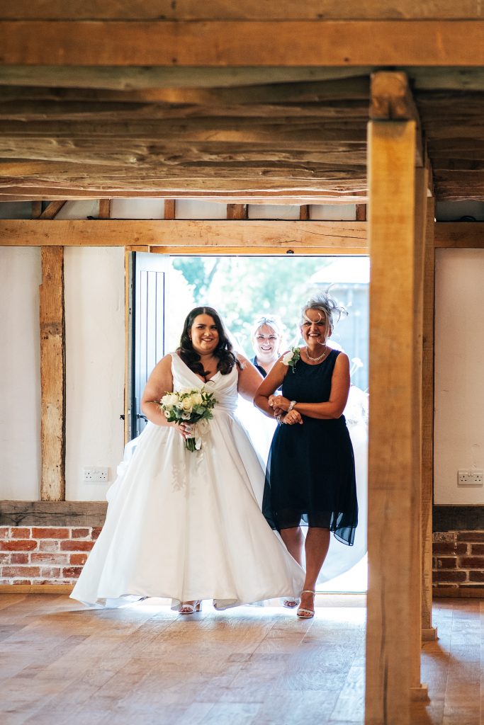 bride walks down aisle with her mum