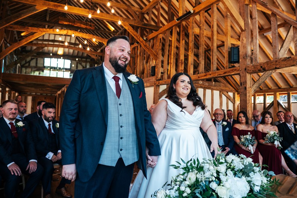 smiling bride and groom during ceremony