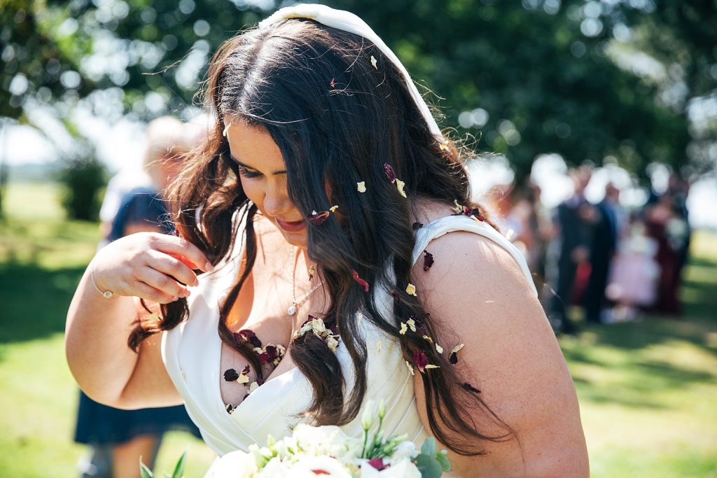 bride gets confetti out of hair