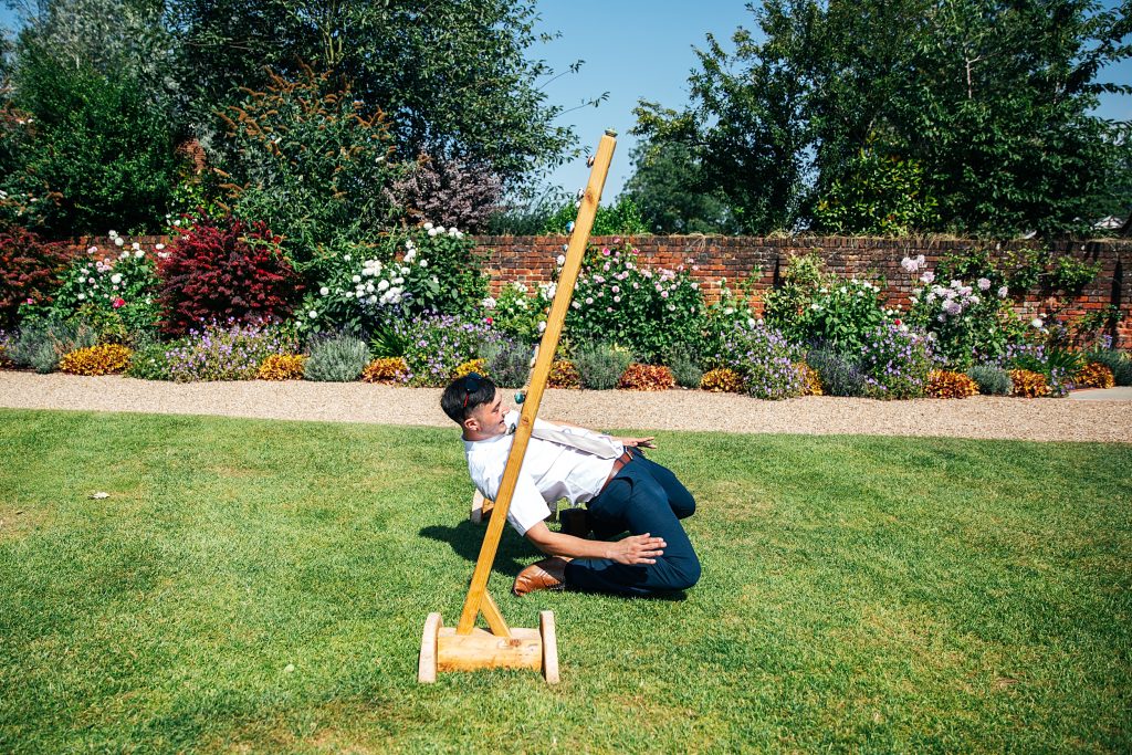 guest plays limbo on a grass lawn