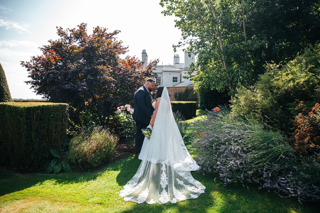Bride and Groom in gardens at Blake Hall