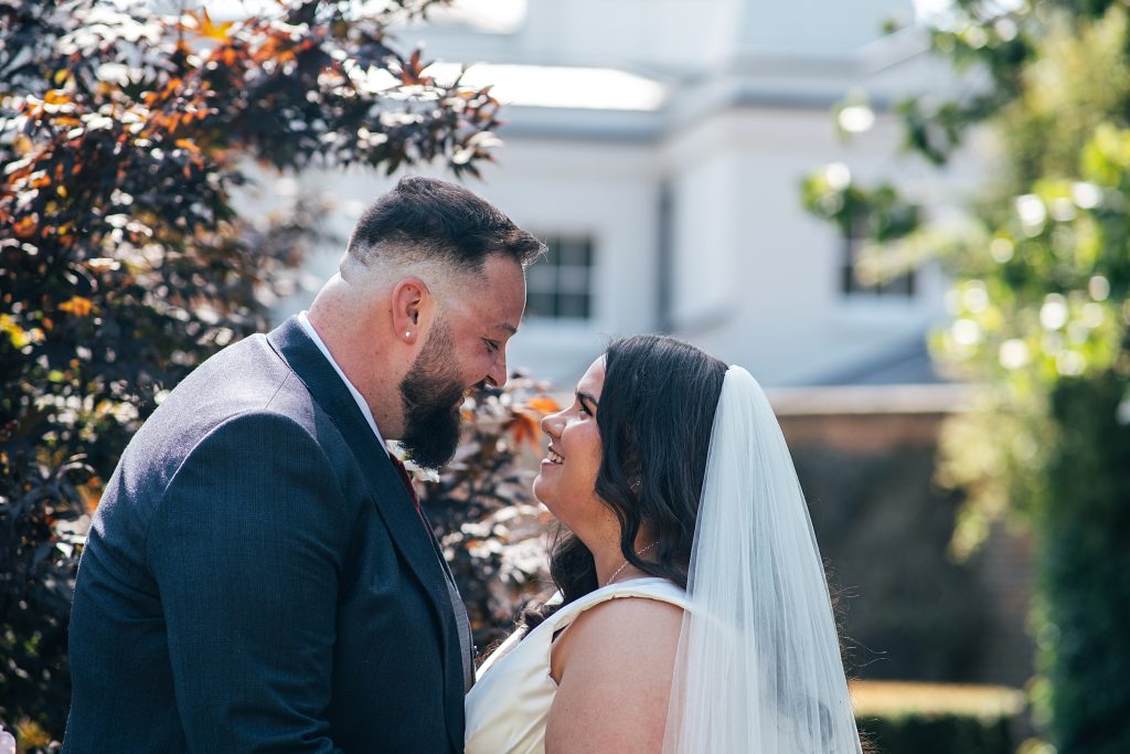 Bride and groom in gardens at Blake Hall