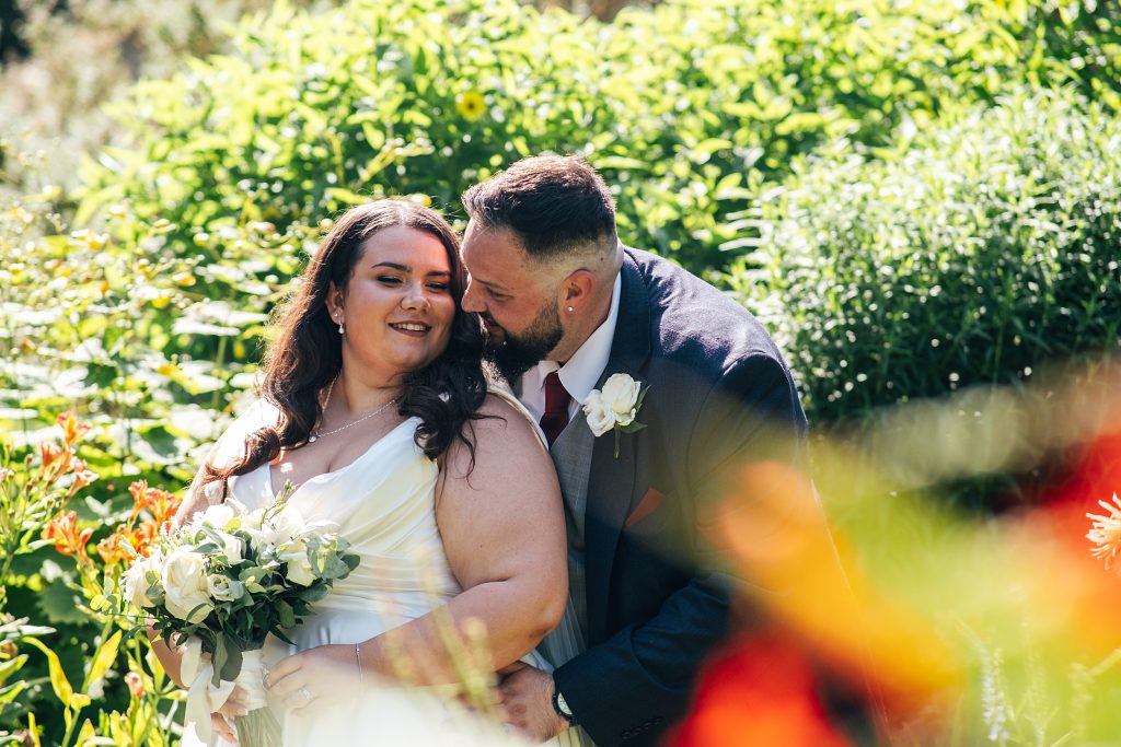 bride and groom in garden at Blake Hall