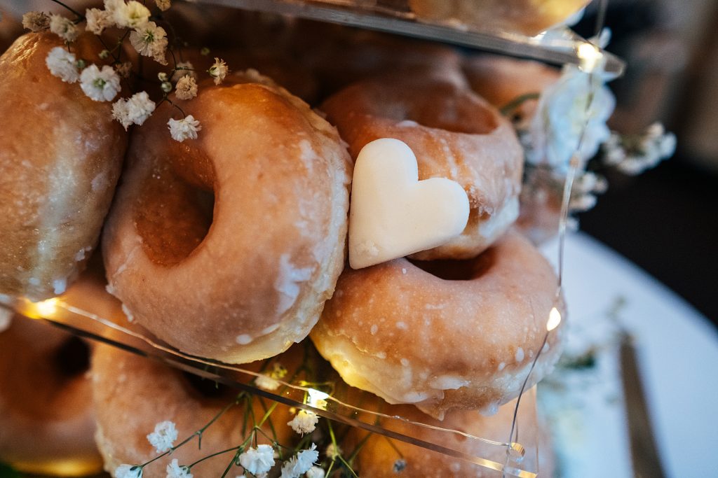 close up of iced heart on donut tower