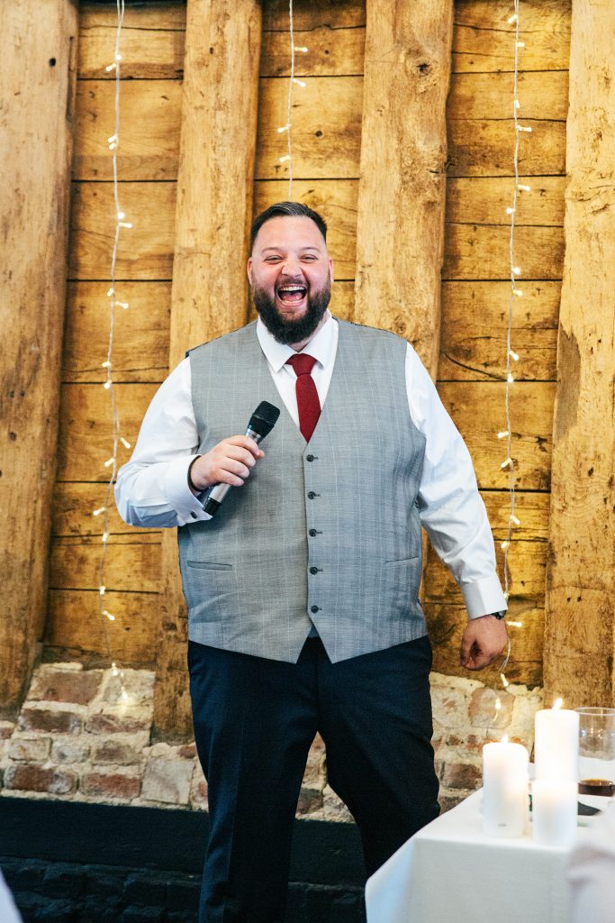 groom laughs during his speech