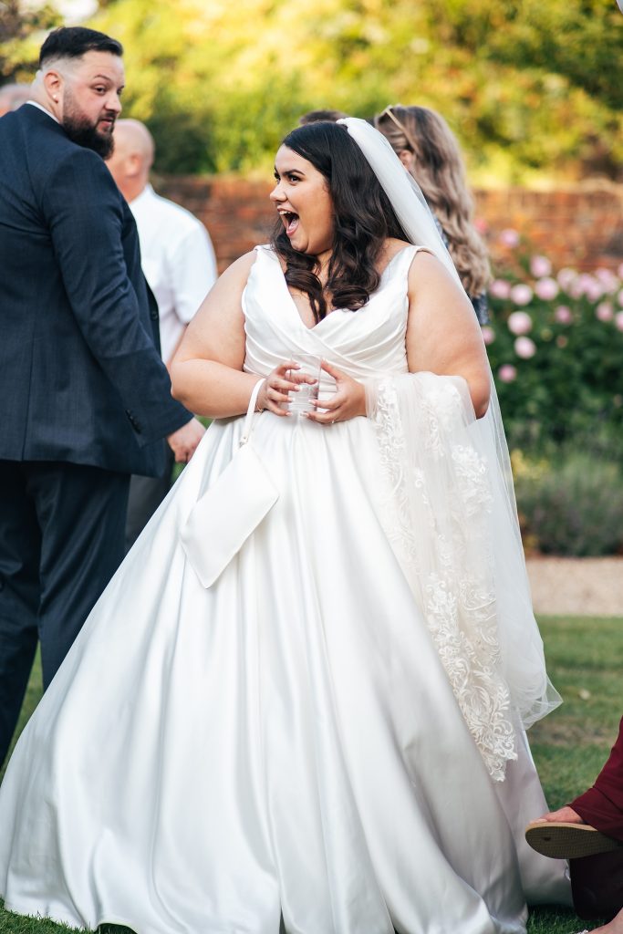 bride laughs on lawn