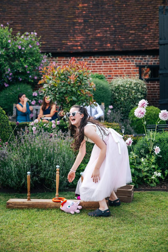 flower girl in heart sunglasses plays lawn game