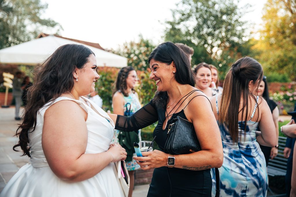 bride laughs with guest in garden