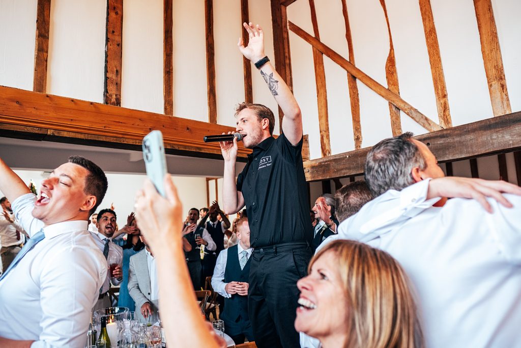 Outdoor Maidens Barn wedding with Singing Waiters Best Essex Wedding Photographer