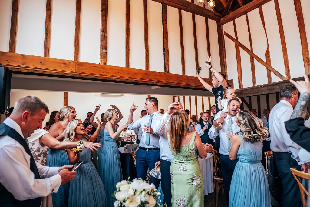 Outdoor Maidens Barn wedding with Singing Waiters Best Essex Wedding Photographer