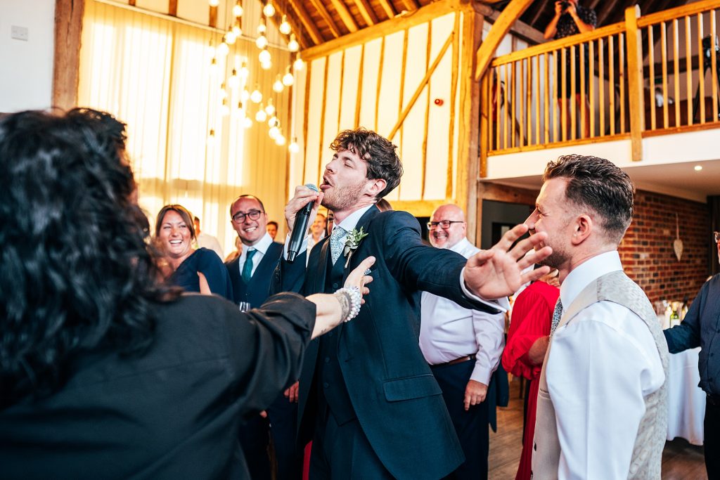 Outdoor Maidens Barn wedding with Singing Waiters Best Essex Wedding Photographer
