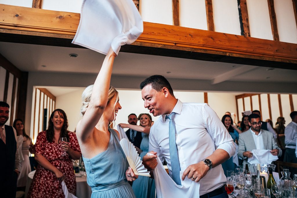 Outdoor Maidens Barn wedding with Singing Waiters Best Essex Wedding Photographer