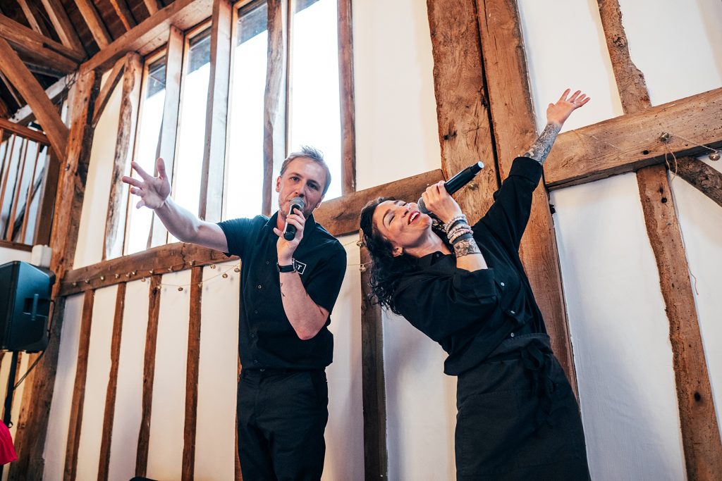 Outdoor Maidens Barn wedding with Singing Waiters Best Essex Wedding Photographer