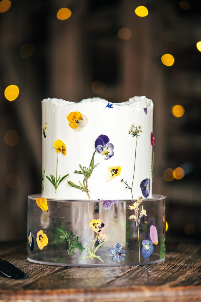 simple one tier wedding cake decorated with pressed pansies