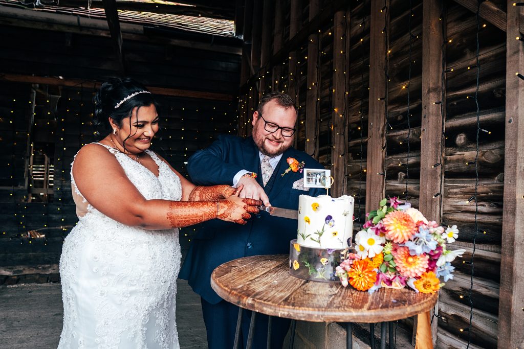 bride and groom cut cake