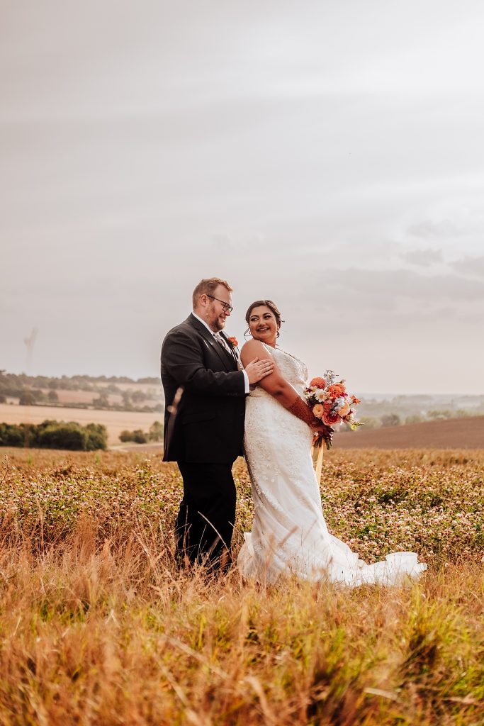 bride and groom in field