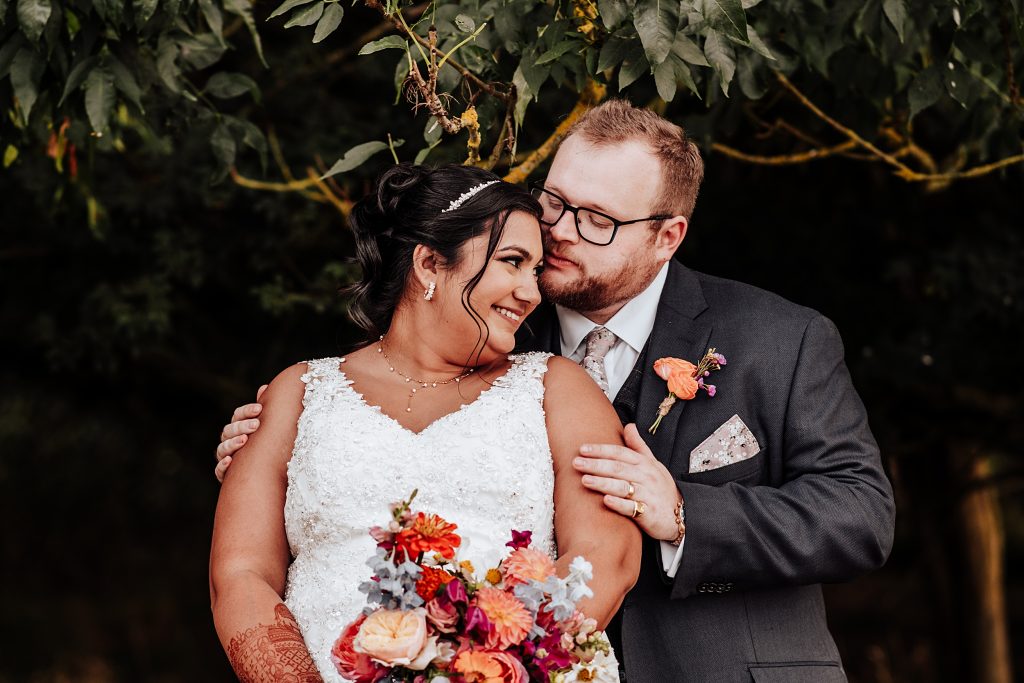 bride and groom under a tree