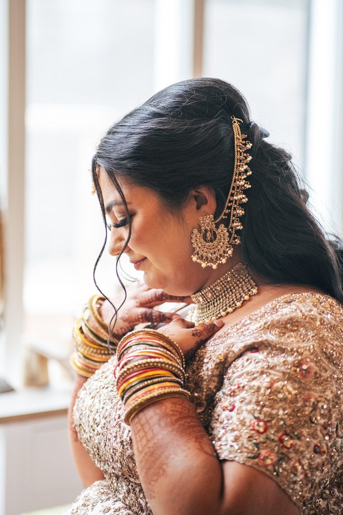 bride adjusts her necklace