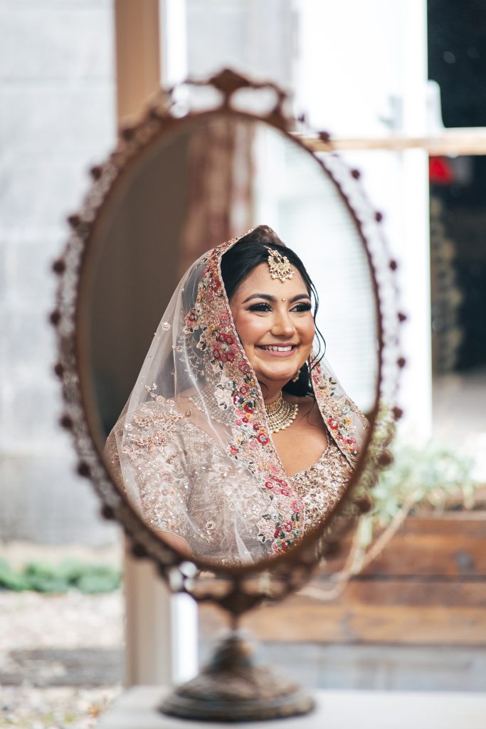 smiling bride's reflection in mirror