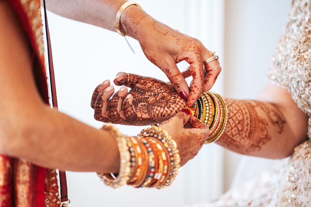 close up of brides sister doing up her bracelets