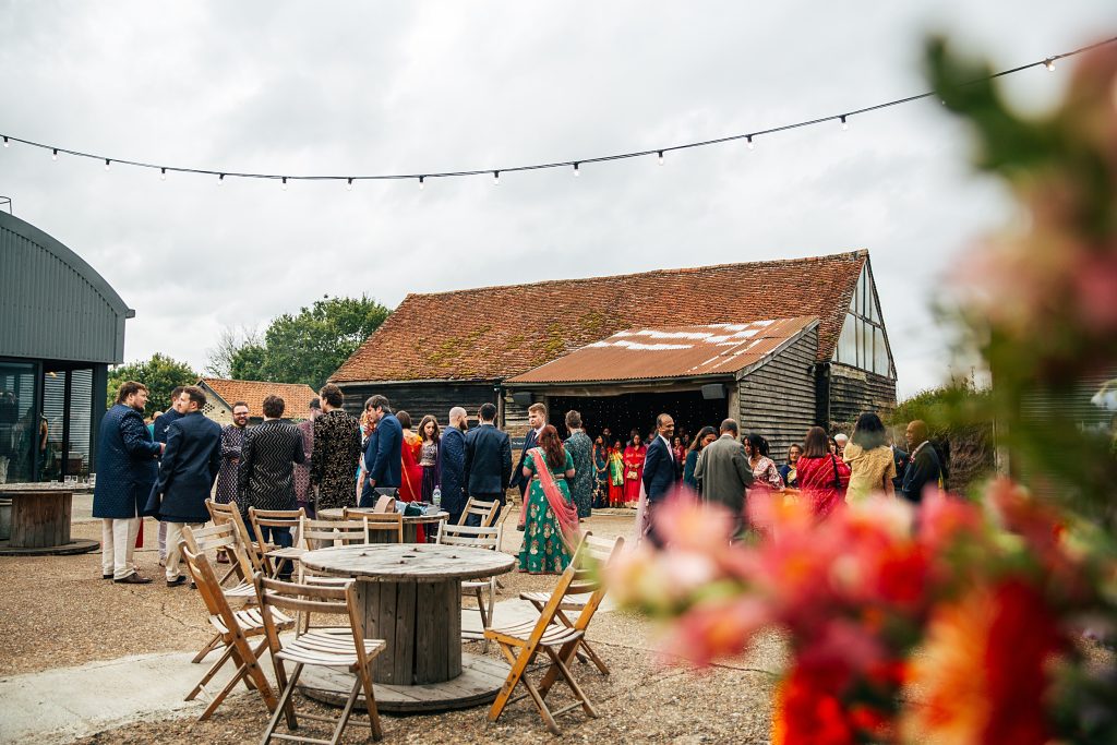 wedding guests gather in courtyard for the Jaan