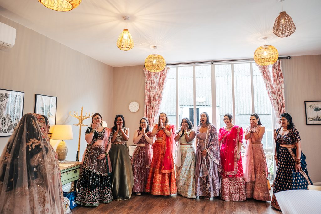 Bride's friends all in tradition indian sari's get emotional as she makes her entrance