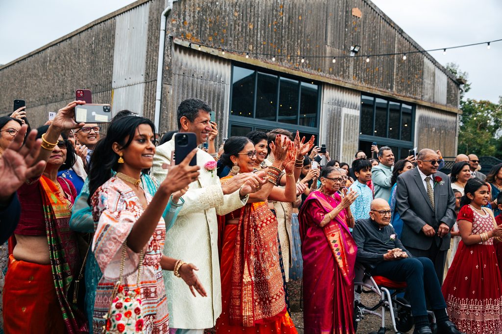Brides family gather, clap and cheer during the Jaan