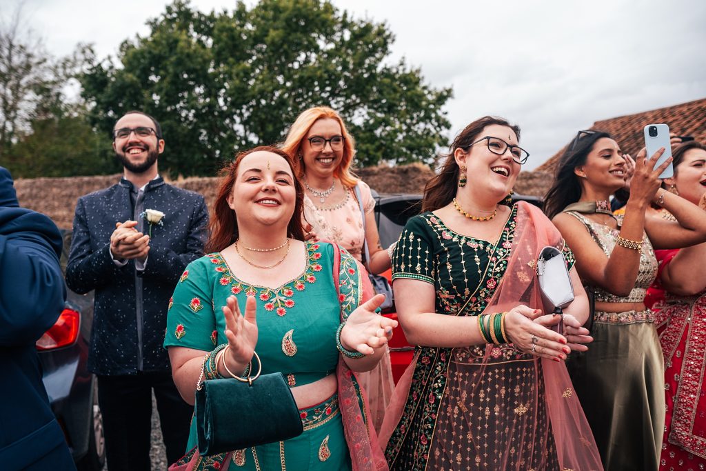 wedding guests clap and cheer during the Jaan