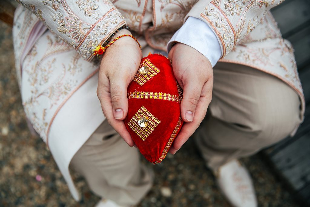 close up of Groom holding Shagun Nariyal