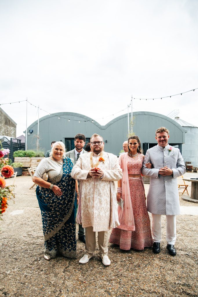 Groom and his family await brides family to greet them