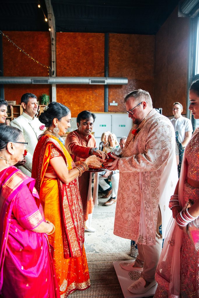 Brides mum and groom exchange offerings and blessings