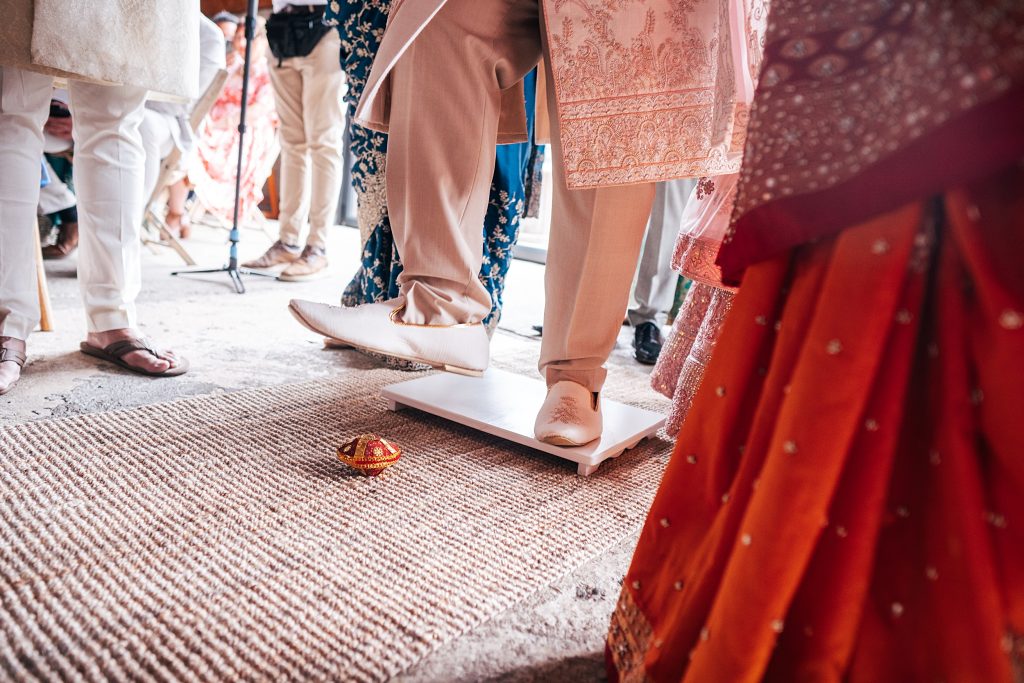 Close up of grooms foot during Baraat