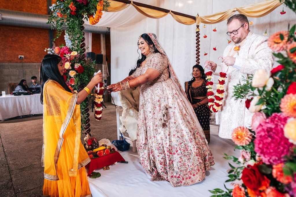 Wedding guests offers bride garland during Varmala