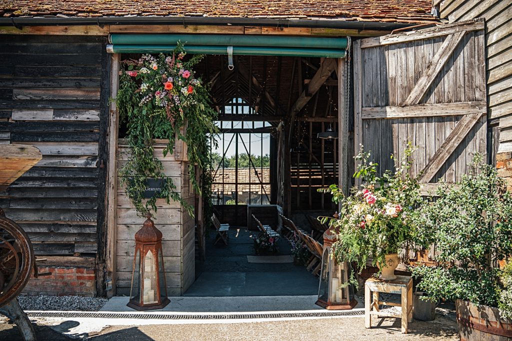 Multi coloured Summer wedding with a bride wearing green at The Barns at Lodge Farm. Essex documentary wedding photographer