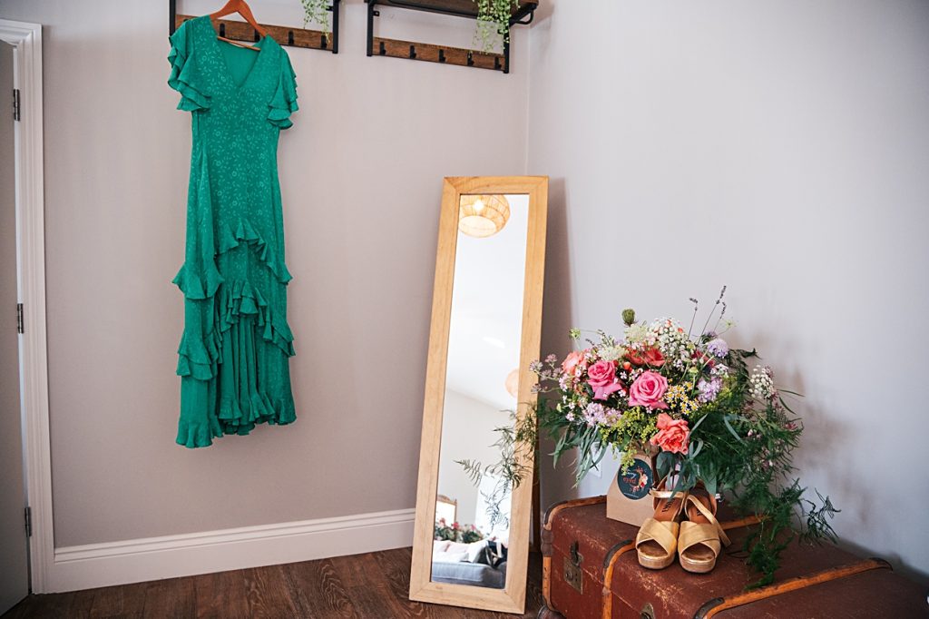 Multi coloured Summer wedding with a bride wearing green at The Barns at Lodge Farm. Essex documentary wedding photographer