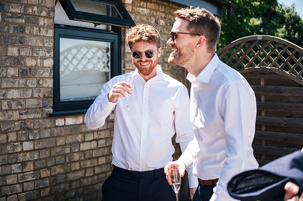 Multi coloured Summer wedding with a bride wearing green at The Barns at Lodge Farm. Essex documentary wedding photographer