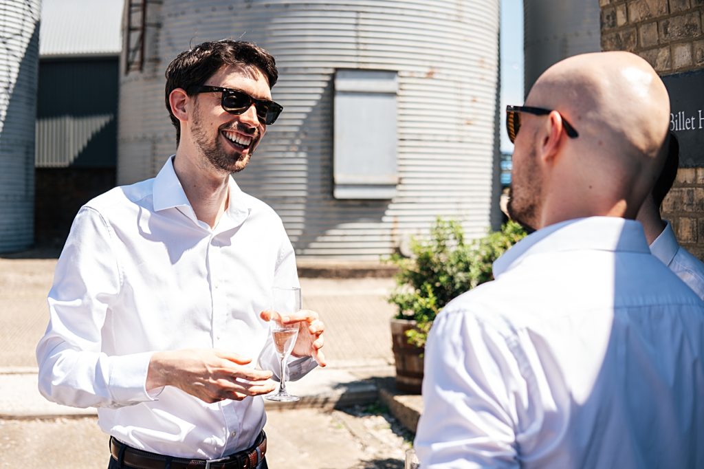 Multi coloured Summer wedding with a bride wearing green at The Barns at Lodge Farm. Essex documentary wedding photographer