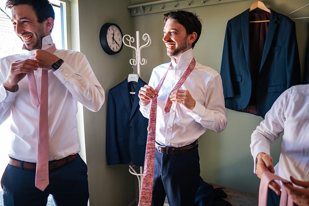 Multi coloured Summer wedding with a bride wearing green at The Barns at Lodge Farm. Essex documentary wedding photographer