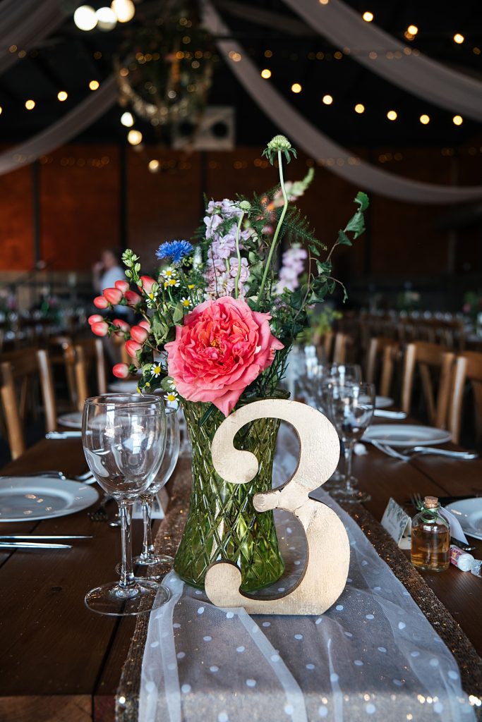 Multi coloured Summer wedding with a bride wearing green at The Barns at Lodge Farm. Essex documentary wedding photographer