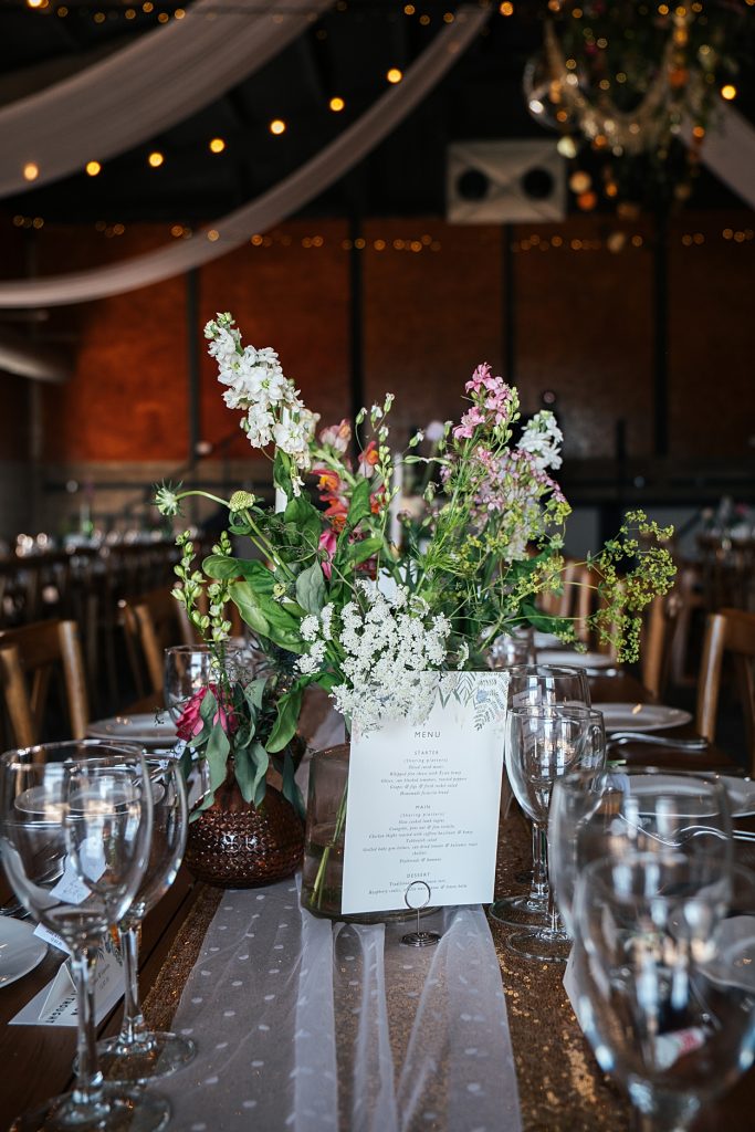Multi coloured Summer wedding with a bride wearing green at The Barns at Lodge Farm. Essex documentary wedding photographer