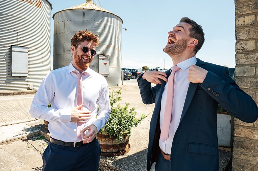 Multi coloured Summer wedding with a bride wearing green at The Barns at Lodge Farm. Essex documentary wedding photographer