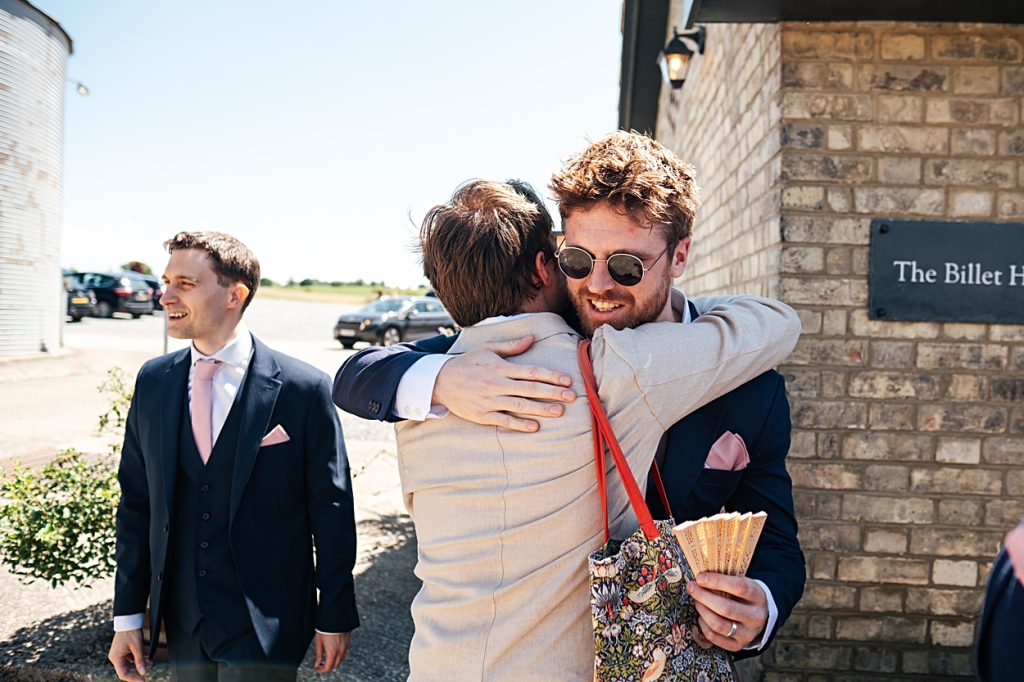Multi coloured Summer wedding with a bride wearing green at The Barns at Lodge Farm. Essex documentary wedding photographer
