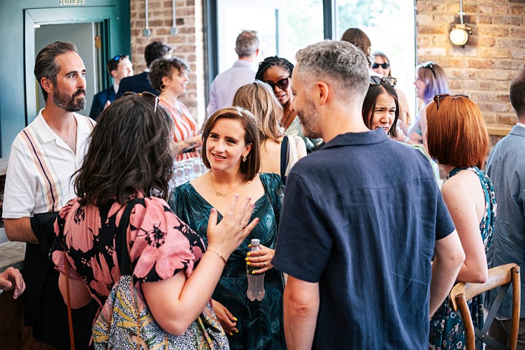 Multi coloured Summer wedding with a bride wearing green at The Barns at Lodge Farm. Essex documentary wedding photographer