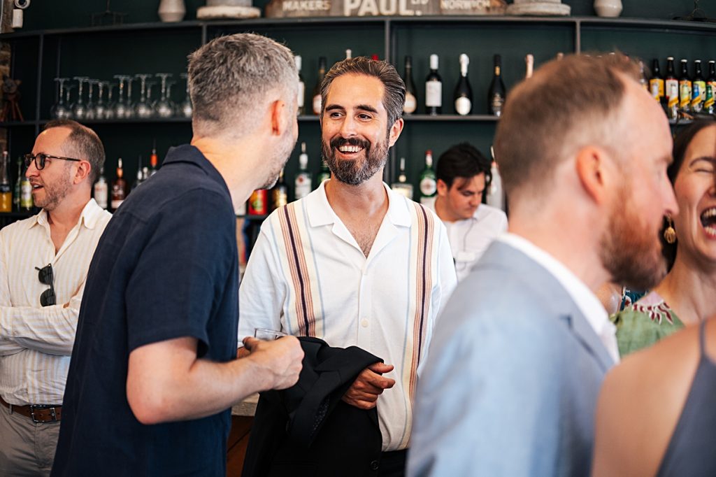 Multi coloured Summer wedding with a bride wearing green at The Barns at Lodge Farm. Essex documentary wedding photographer