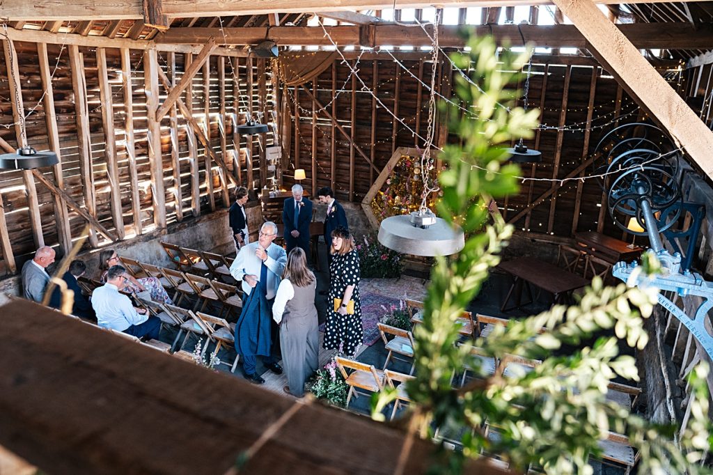 Multi coloured Summer wedding with a bride wearing green at The Barns at Lodge Farm. Essex documentary wedding photographer